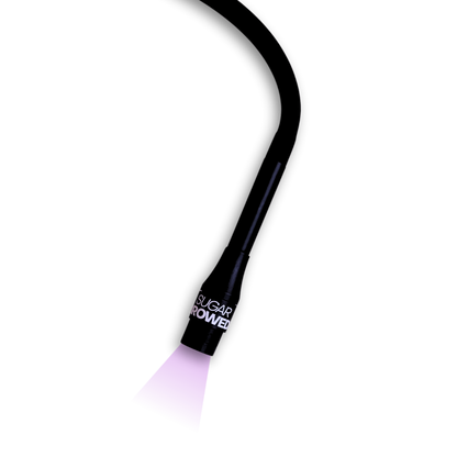 Sugar Browed UV Light Pro S7 in action with vibrant curing light — advanced tool for activating adhesive during real human hair eyebrow extension treatments. Designed for precision and fast, professional brow results.